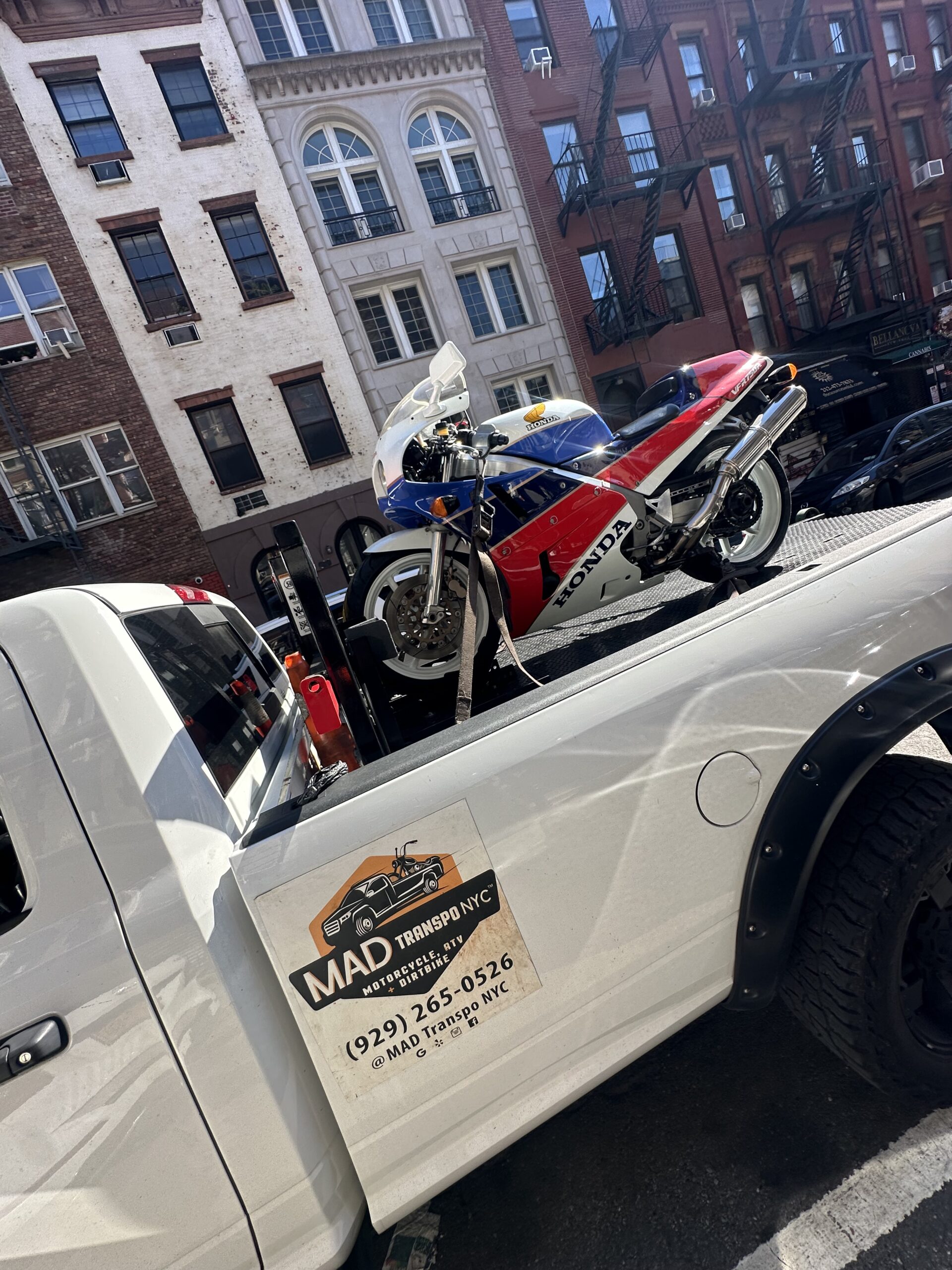Red and white sport motorcycle on the MAD Transpo NYC pickup