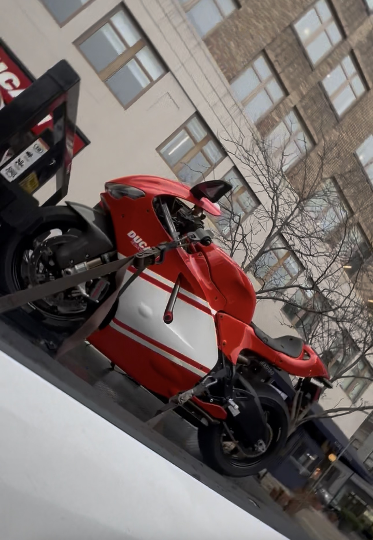Red and white scooter secured on the transport deck