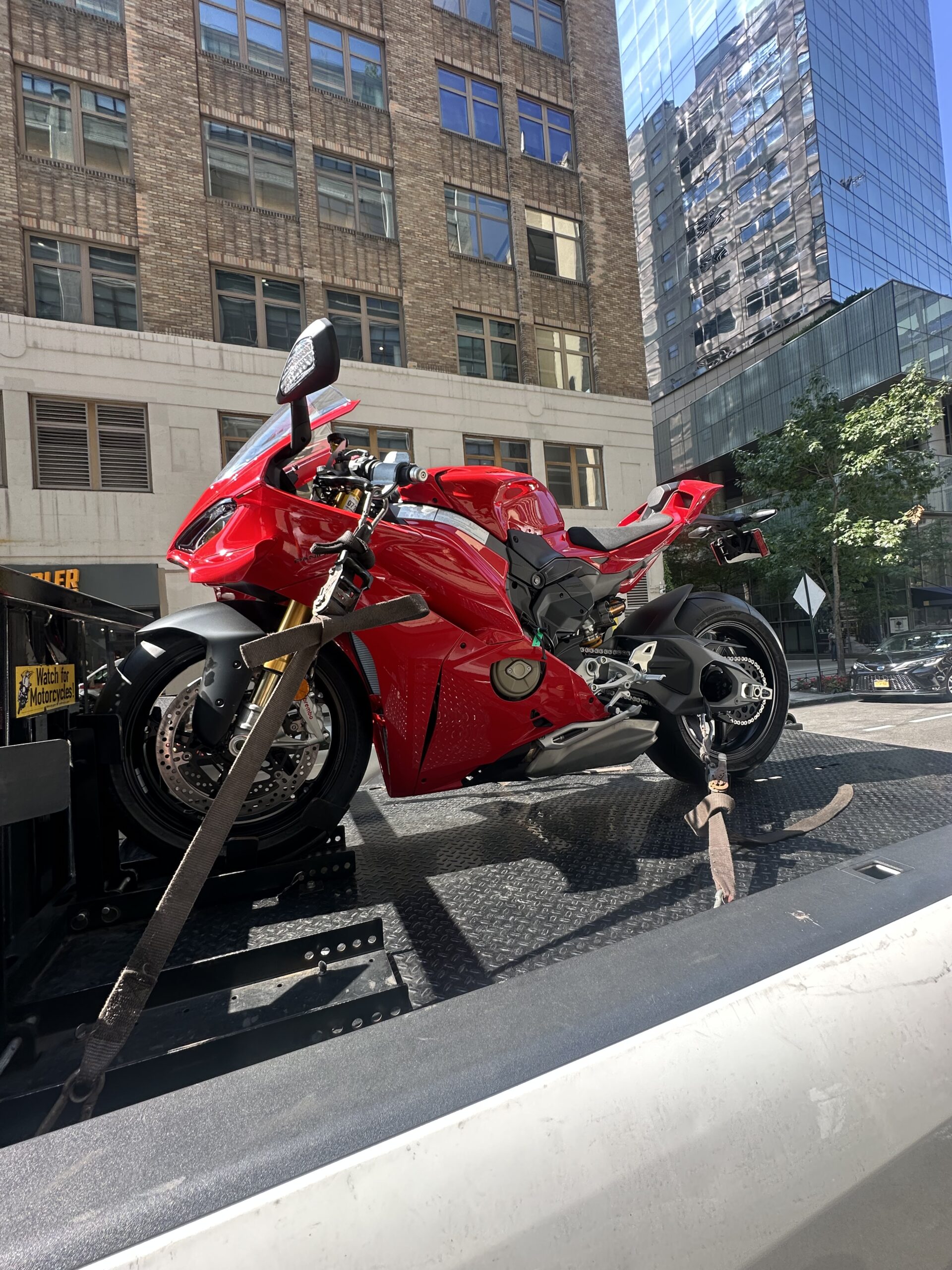Red sport motorcycle loaded for transport in New York City