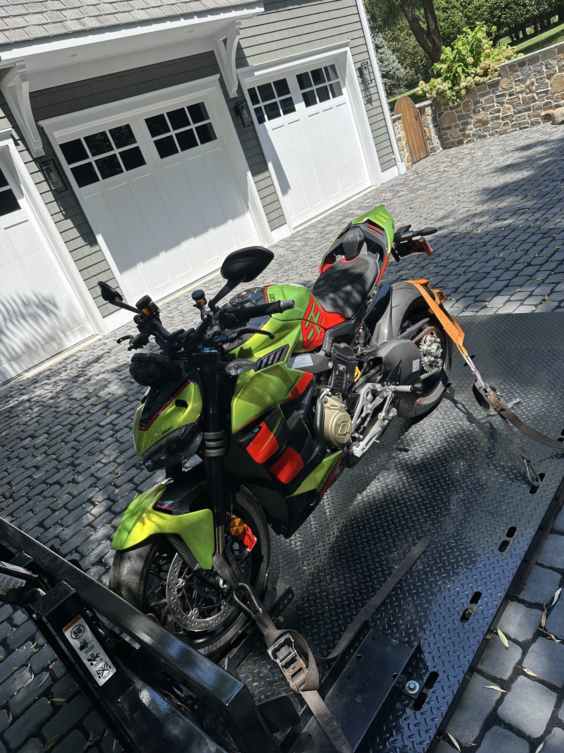 Green custom motorcycle secured for transport
