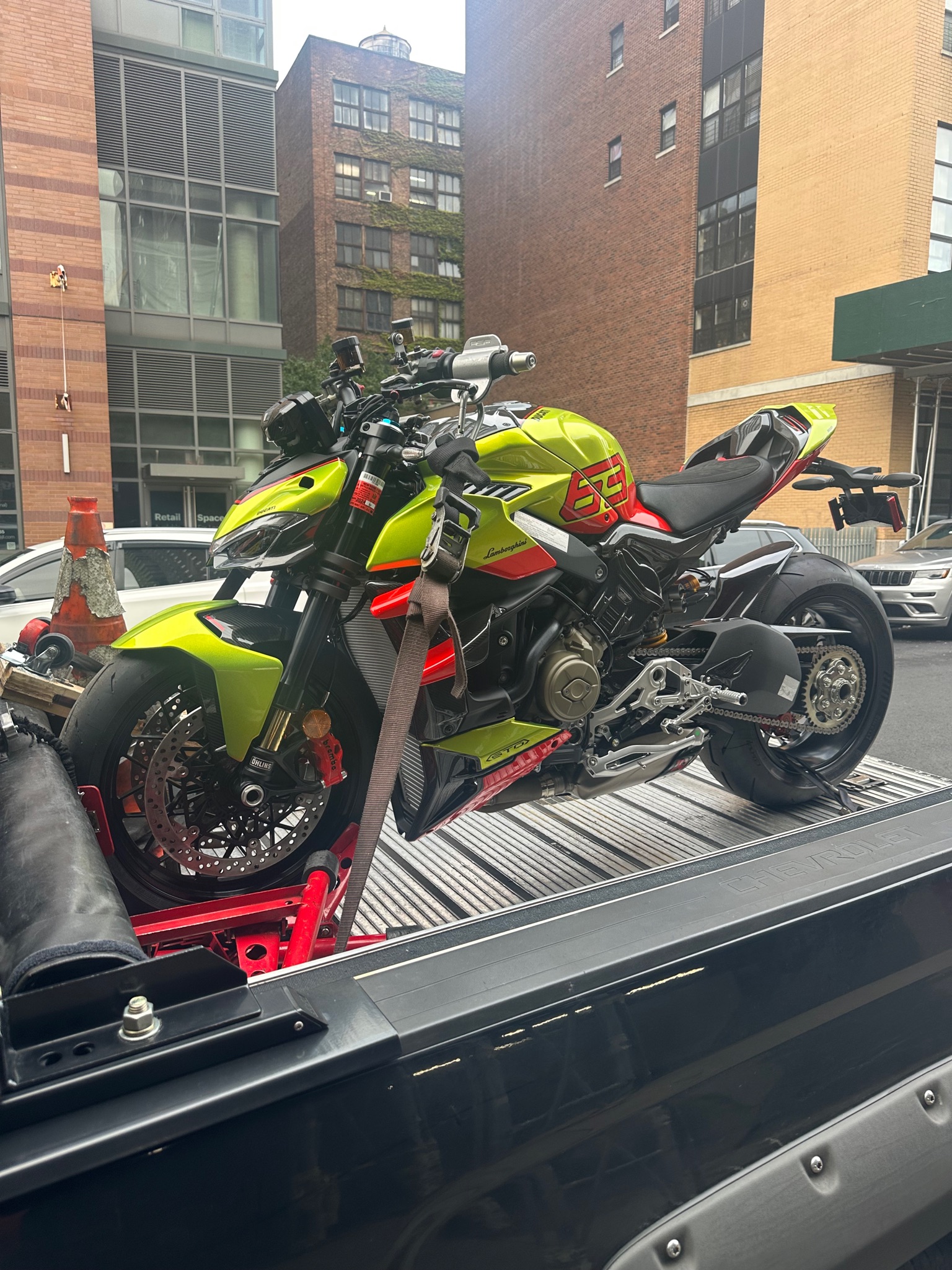 Bright yellow motorcycle loaded for transport in the city