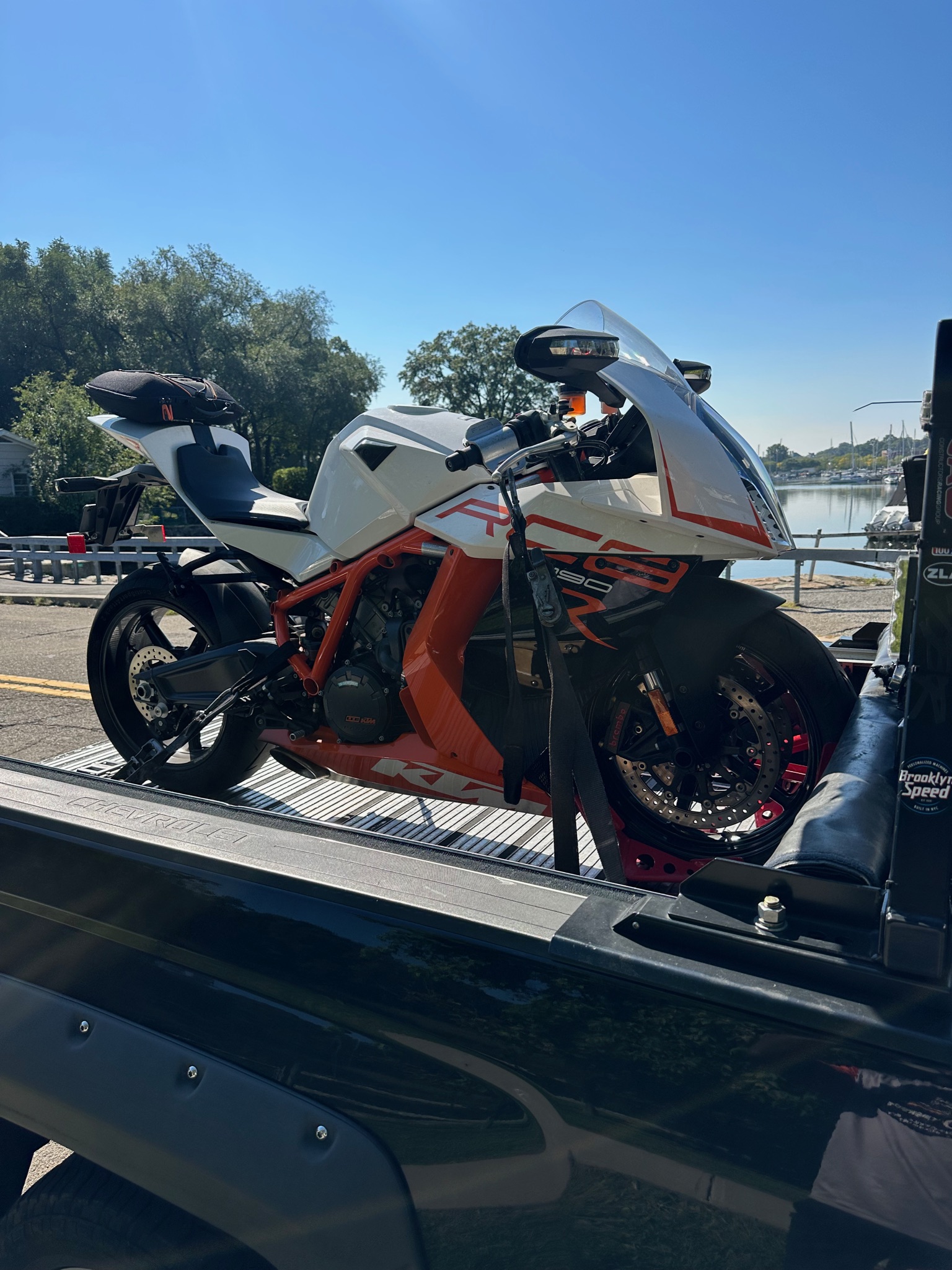 Sport motorcycle secured for delivery on the transport deck