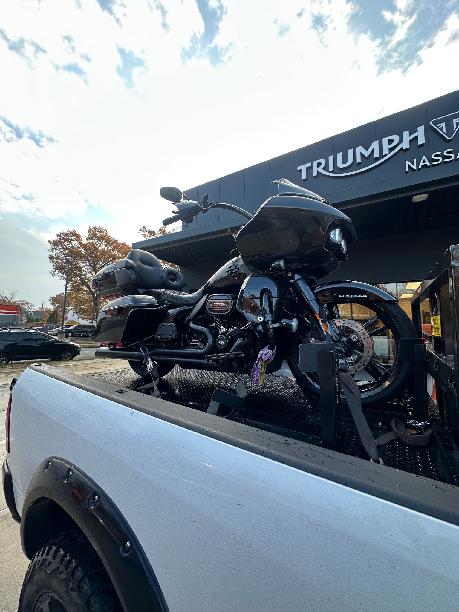 Black motorcycle transported outside a Triumph dealership