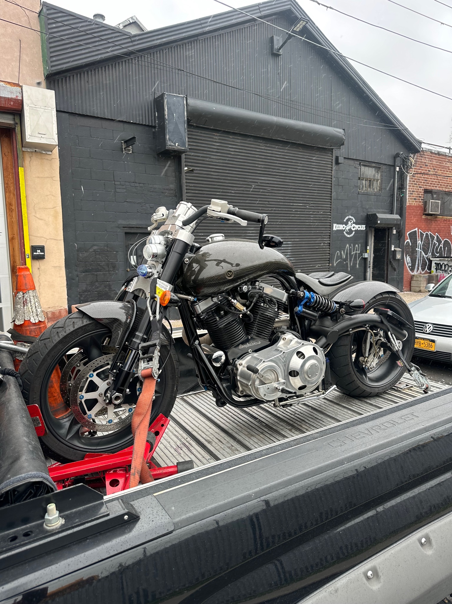 Silver and black motorcycle strapped to the transport deck