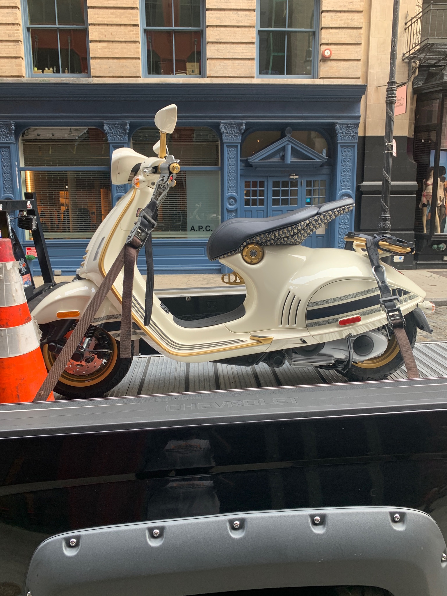 Cream scooter secured for delivery
