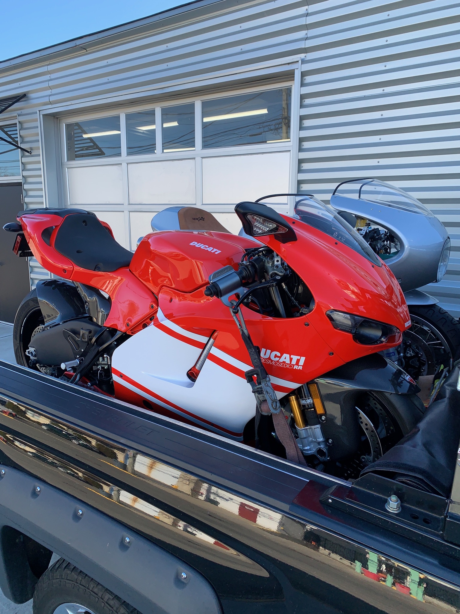 Red sport motorcycles secured side by side on the transport deck