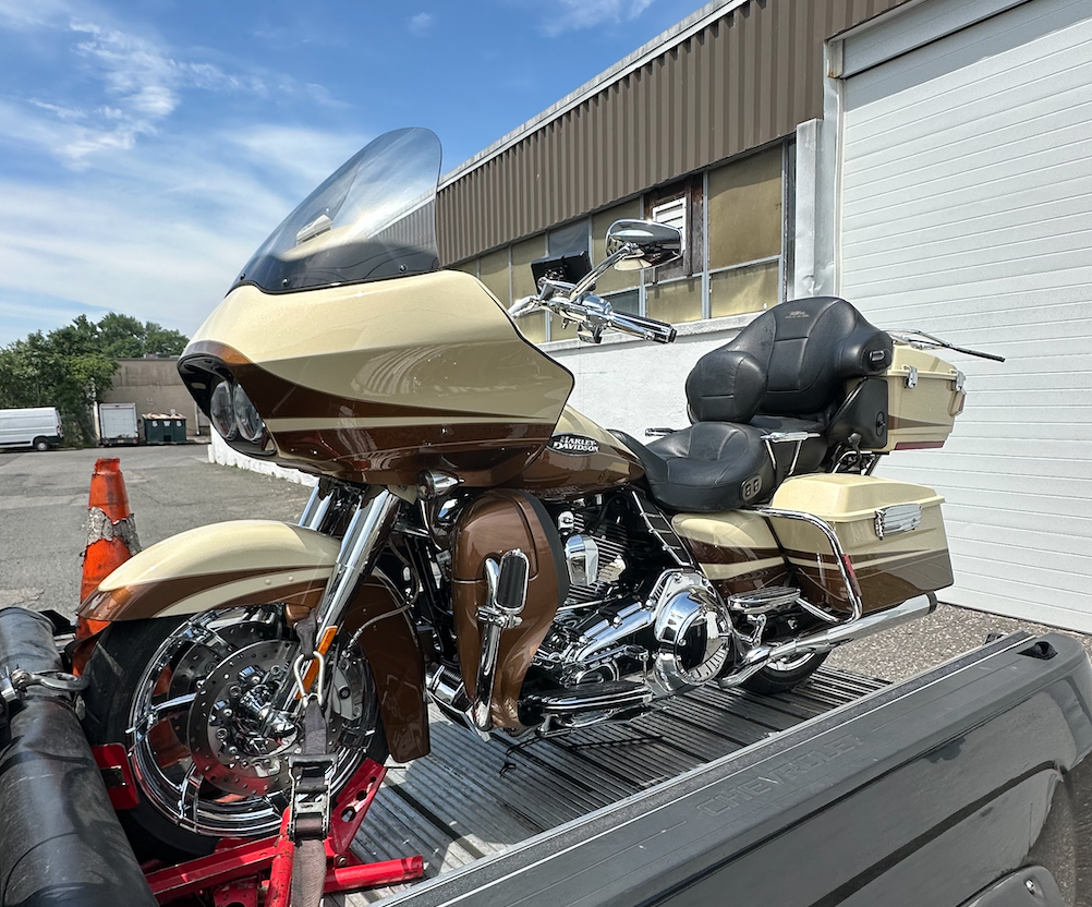 Gold touring motorcycle secured on the transport deck
