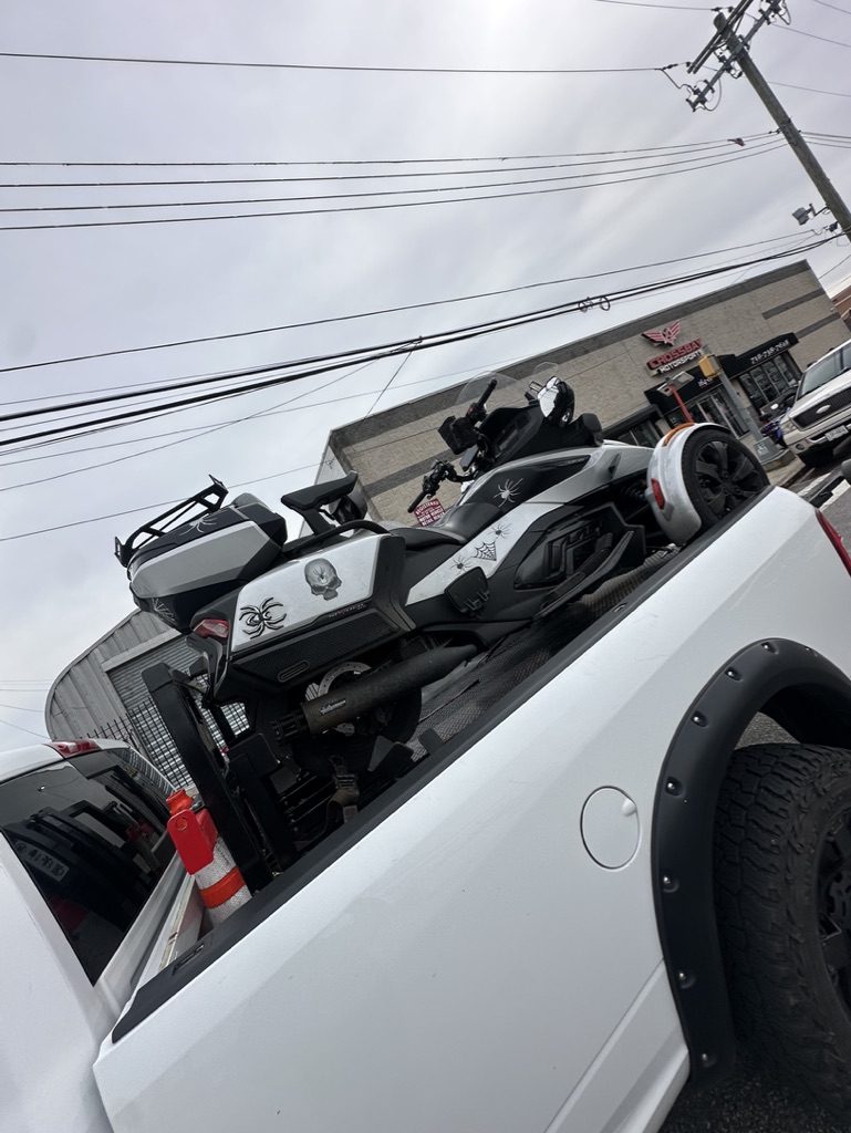 Black three-wheel motorcycle secured on the pickup