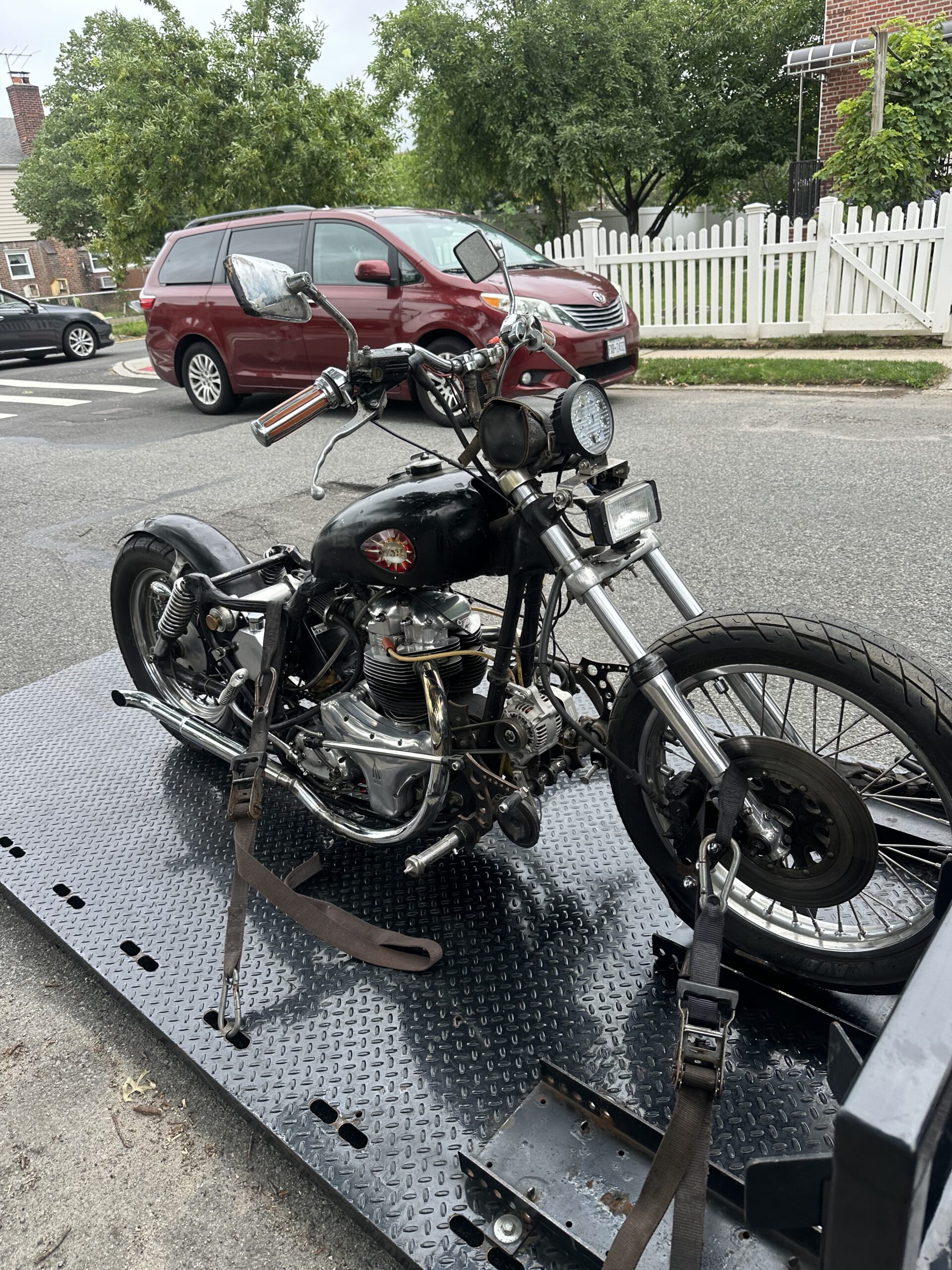 Vintage black motorcycle secured on the transport deck